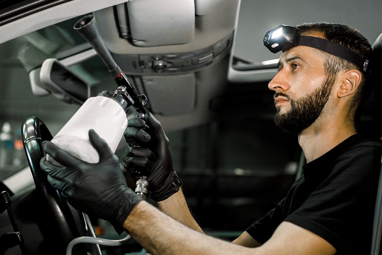 Technician performing auto glass baton rouge service on a windshield
